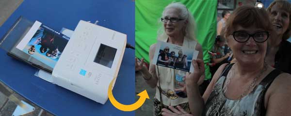 happy lady smiling with her printed photo from green screen photo booth